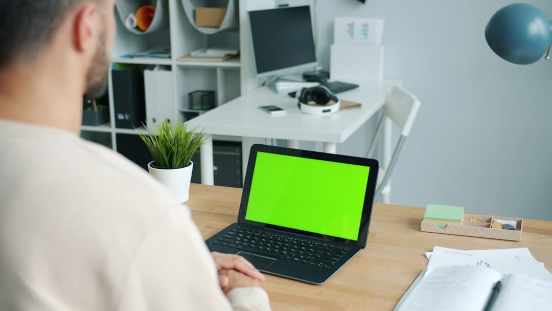 Person reviewing data and providing feedback on a computer screen