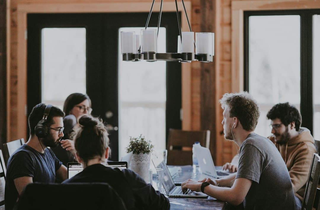 Busy small office with a team working at shared desks