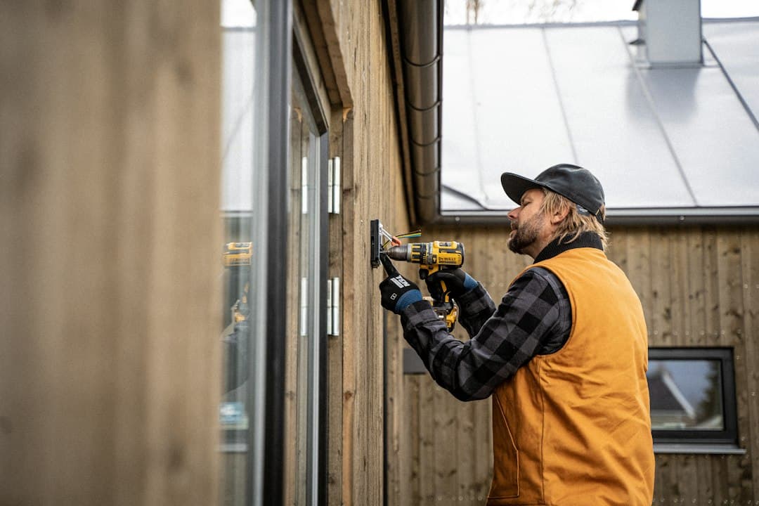 Tradesperson using a drill on a building site